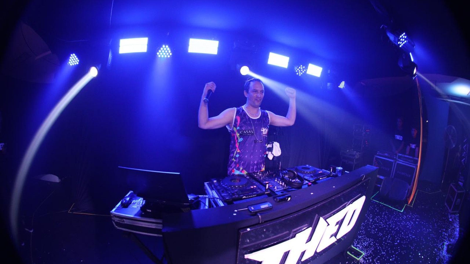 DJ Theo no palco com iluminação azul